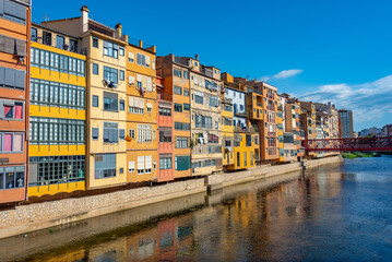Colorful houses alongside river in the center of Girona, Spain