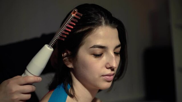 Medical darsonvalization procedure for a young woman