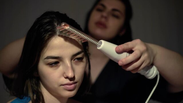 Medical darsonvalization procedure for a young woman