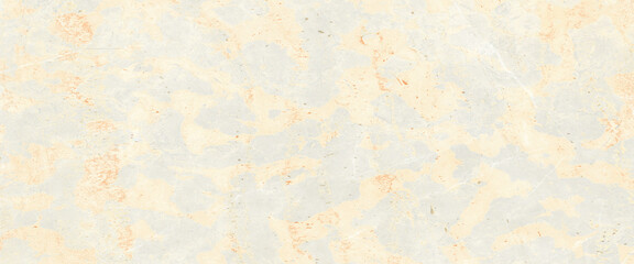 The surface of natural stone beige and light brown shades with hints of golden light covered with a homogeneous network of thin veins