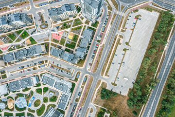 residential neighborhood with multistory apartment buildings and outdoor parking lot. aerial view.