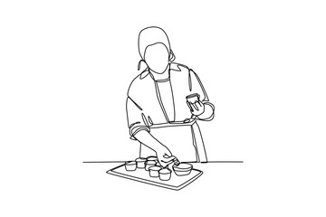 Naklejka na ściany i meble Continuous one-line drawing a chef decorating cupcakes. Kitchen activity concept. Single line drawing design graphic vector illustration