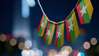 A garland of Myanmar national flags on an abstract blurred background