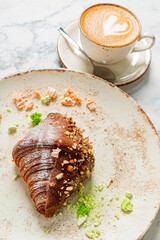 fresh croissant with cup of coffee