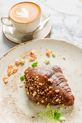 fresh croissant with cup of coffee