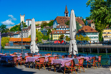 Restaurant with a view of panorama of Spreuerbruecke and historical fortification at Swiss town...