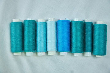 Close - up of coils of threads of different colors and shades for sewing, embroidery and creativity. The concept of Hobbies and crafts.