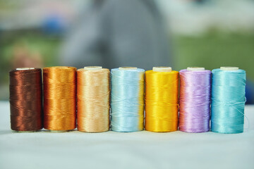 Close - up of coils of threads of different colors and shades for sewing, embroidery and creativity. The concept of Hobbies and crafts.