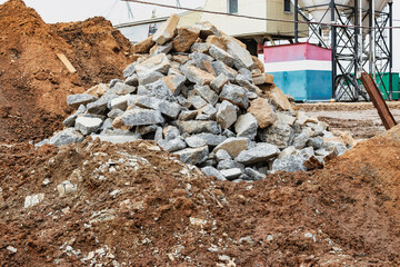 Recycling of concrete and building materials. A pile of concrete scrap at a construction site. Reuse of materials after dismantling. Ecology.