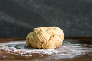 Bakery - yeast dough for bread, pizza or scone on a floured surface, with flour splash. Cooking...