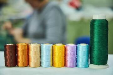 Close - up of coils of threads of different colors and shades for sewing, embroidery and creativity. The concept of Hobbies and crafts.