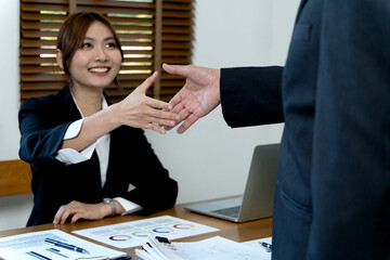 young business woman are shaking hands to congratulate the success of the work