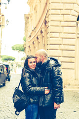  Portrait  of Happy  Tourists  couple   in love traveling at Rome, Italy,    Hugging   at Campidoglio Square.Concept of Italian travel. 