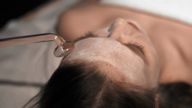 Massage of the patient's face in the spa using Darsonval