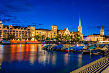 Sunset view of historic Zuerich city center with famous Fraumuenster Church and river Limmat on a...
