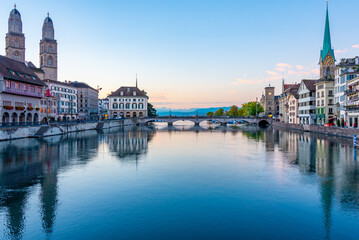 Sunrise view of historic city center of Zuerich with famous Fraumuenster and Grossmuenster Churches and river Limmat ,Switzerland