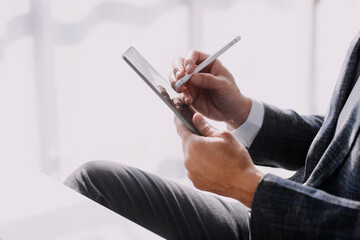 Financial analysts analyze business financial reports on a digital tablet planning investment project during a discussion at a meeting of corporate showing the results of their successful teamwork.