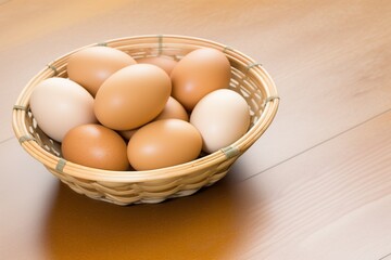 eggs in a basket, eggs in a basket on a wooden table