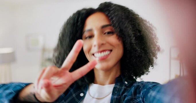 Peace, kiss and selfie by black woman on a sofa, happy and having fun in her home. Portrait, hand and social media girl influencer live streaming for blog, smile and pose for photo or profile picture