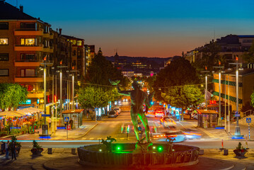 Sunset view of Kungsportsavenyen boulevard with Poseidon statue in Göteborg, Sweden