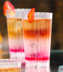 Cocktail with strawberries in nature.