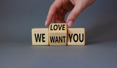 We love and want You symbol. Businessman Hand turns cubes and changes word We want you to We love you. Beautiful grey background. Business and We love and want You concept. Copy space