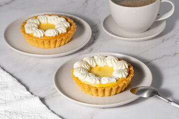 Creamy cheesecake cake and coffee on a light table