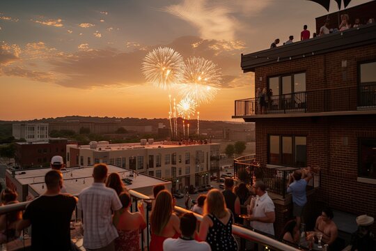A group of people gathered on a rooftop deck enjoying a 4th of July sunset and fireworks display. Generative AI