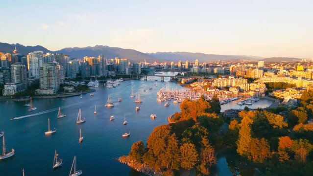 Vancouver downtown skyline aerial flythrough over marina, BC, Canada at sunset