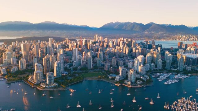 Vancouver downtown skyline aerial pullback reveal shot, BC, Canada at sunset