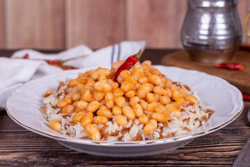 Dry bean pilaf. Traditional Turkish cuisine. Turkish dry beans and rice with ayran and hot pepper. local name kuru fasülye pilav. Close up