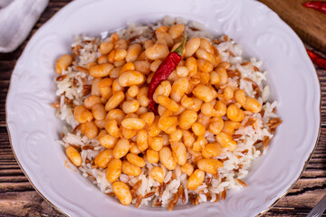 Dry bean pilaf. Traditional Turkish cuisine. Turkish dry beans and rice with ayran and hot pepper. local name kuru fasülye pilav. Close up