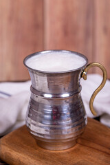 Buttermilk. Sparkling buttermilk in an iron glass. Beverage prepared with yogurt and water. Traditional Turkish delicacies. local name ayran