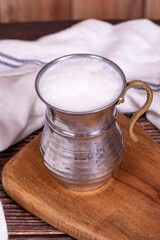 Buttermilk. Sparkling buttermilk in an iron glass. Beverage prepared with yogurt and water. Traditional Turkish delicacies. local name ayran
