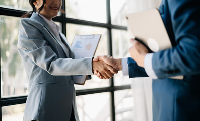 Two confident business man shaking hands during a meeting in the office, success, dealing, greeting and partner