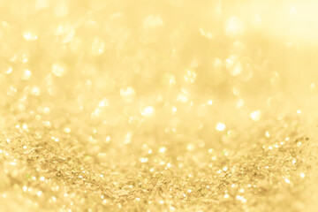Gold light Festive Christmas background. Abstract twinkled bright background with bokeh defocused golden lights