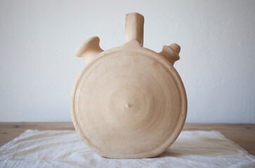 White earthenware botijo, traditional clay pot jug