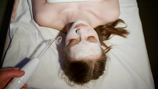 Massage of the patient's face in the spa using Darsonval