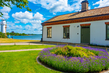 Lighthouse at traditional port buildings in Karlshamn, Sweden.