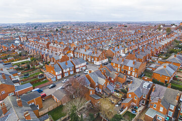 scenic drone shot of orange houses with grey rooftops, Wollaton suburb, Nottingham, United Kingdom....