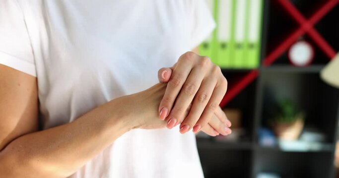 Nervous woman in white t-shirt rumples hands in expectation