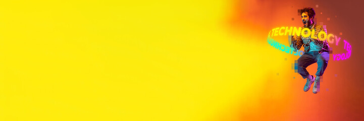 Banner with jumping and screaming man with neon lettering technology around body over yellow and orange background. Copy space for ad