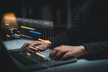 Planning and Implementation, Business people use laptop computers to manage work projects and update tasks. Work progress, efficient scheduling.Business Data Management scheduling interface