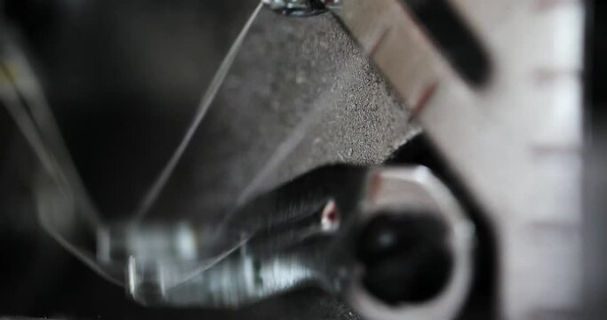 working mechanisms of an overlock sewing machine. macro. overlock details in motion