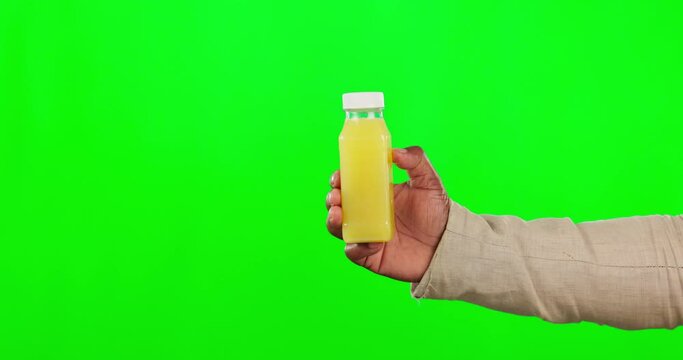 Hand, juice and mockup on a green screen background in studio for health, nutrition or detox for wellness. Bottle, product and diet with a person holding a container for weight loss or vitamins