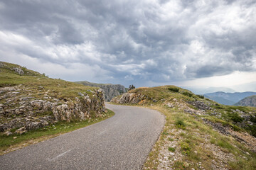 Empty road in highlands of Montenegro in stormy weather.