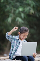 A girl is using a laptop computer for education and learning online.