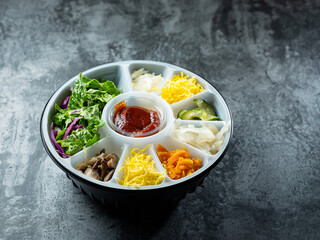 Various vegetables in packaging containers, bibimbap