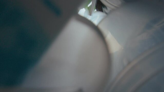 Sorted plastic waste falling down from a paper bag into the rubbish bin. Eco-friendly, recycling, sustainable living concepts. POV shot from the bottom of trash can