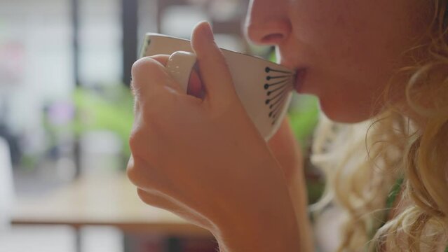 Young Woman, Takes a Mug with a Hot Drink in Her Hands and Brings it to Her Lips